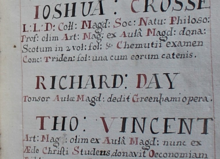Close up of hand written entry in red and black ink reads 'Richard: Day Tonsor Aulae Magd: dedit Greenhamio opera.'