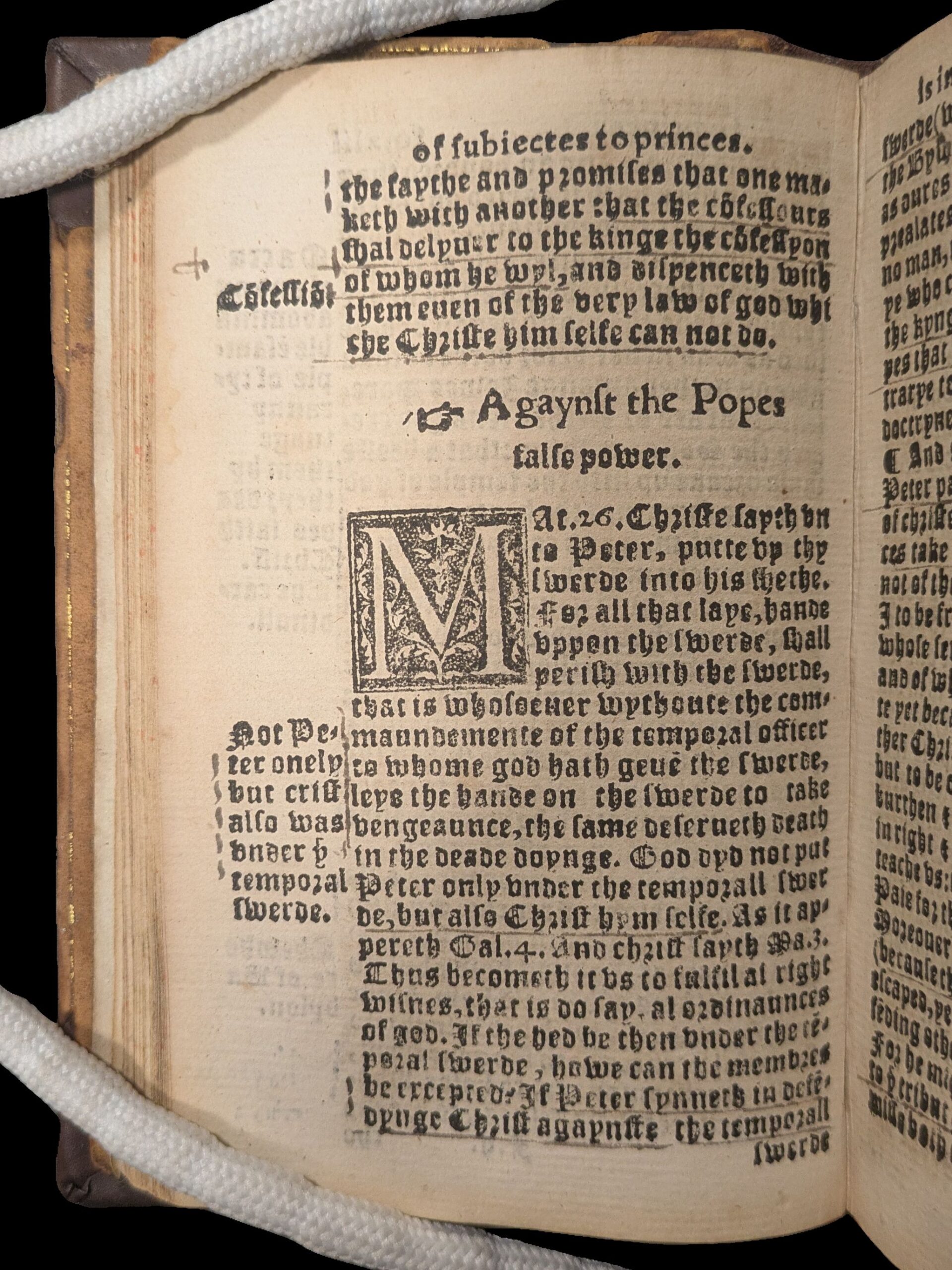 Page filled with gothic text. Title in centre of page has a manicle (hand with pointing finger) and title reading 'Against the Popes'