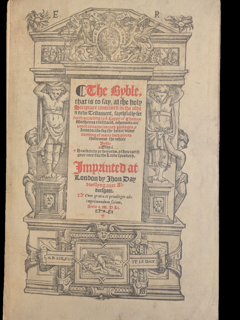 Title page with black and red print in centre and decorative border.
