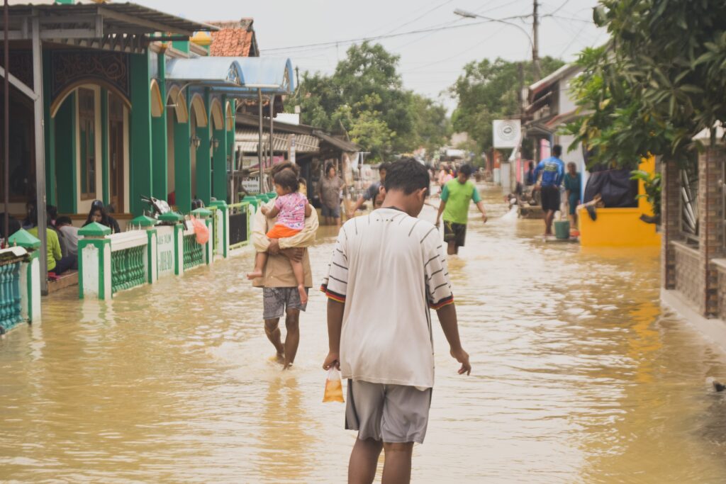 People wading through flood water.