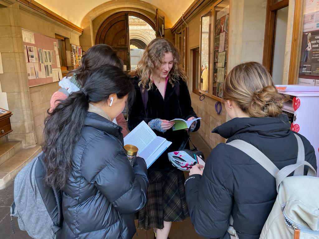 Students gather around the Hertford temporary bookcase on International Book Giving Day (14 February 2023)