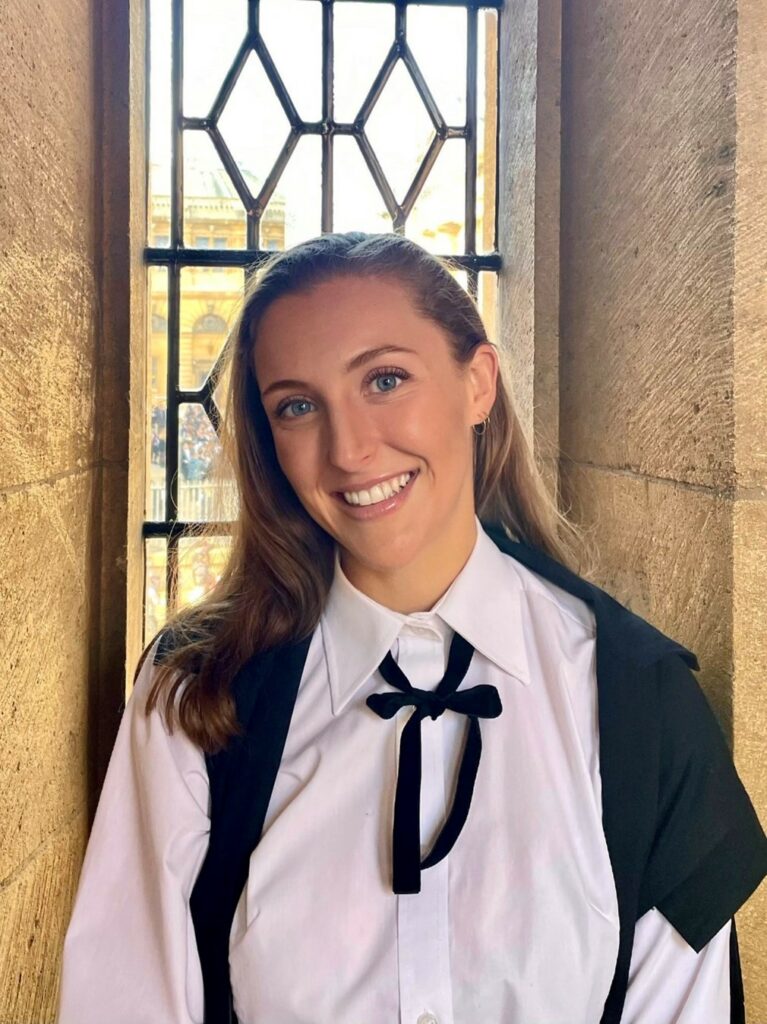 Image of Lara Bampfield in academic gown, pictured on the Bridge of Sighs. 