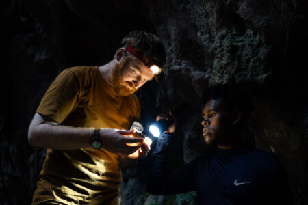 Dr Dylan Gaffney examining an artefact with Alex Lapon.