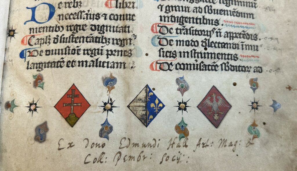 Close up of three heraldic coats of arms.