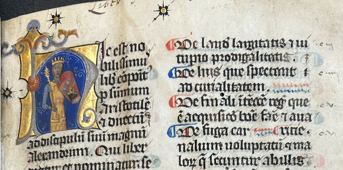 Close up of first page of MS 2 showing illuminated gold first letter and manuscript text