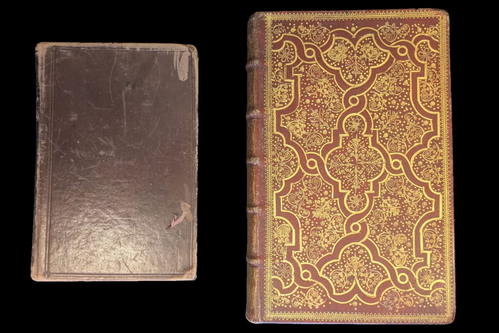Two books side by side on a black background. The book on the left has a plain brown leather cover and the book on the right is larger and has a red leather cover and elaborate gold decoration.